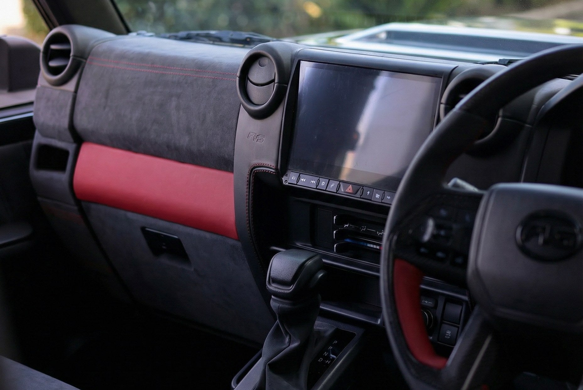 Toyota LandCruiser 70 Series interior with an aftermarket headunit and PVS dashboard