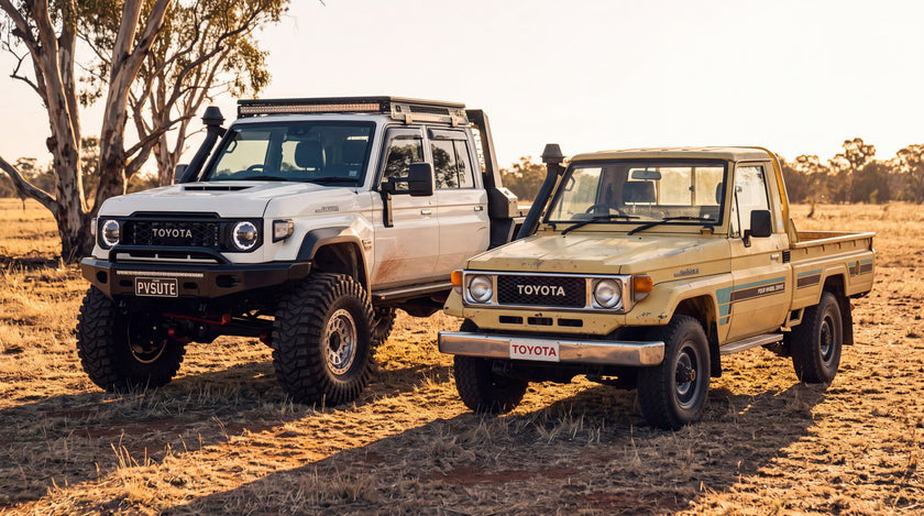 An early LandCruiser 70 Series in faded paint beside a current model 70 Series ute