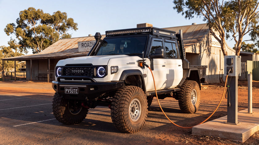 A plug-in hybrid dual cab ute charging at a rural Australian roadhouse